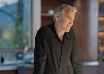 A man with grey hair smiles