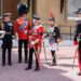 King Charles talks to Prince William while Princess Anne looks on