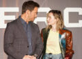 Chris Pratt and Rebecca Ferguson stand next to each other as they pose for photographers.