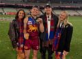 Lachie Neale and Jules Neale with Ben Crosley and Tess Crosley after Brisbane's 2025 grand final win.