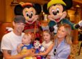 Ashley Tisdale (right) and family pose with Mickey Mouse and Minnie Mouse while dining at Storytellers Cafe on Sep. 3, 2025, in Anaheim, California.