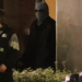 Bad Bunny in a horned beanie and dark sunglasses at night.