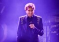 Barry Manilow performing on stage with a microphone.