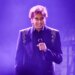 Barry Manilow performing on stage with a microphone.