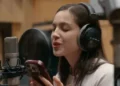 Warchild Olivia Rodrigo sings while reading lyrics from her phone