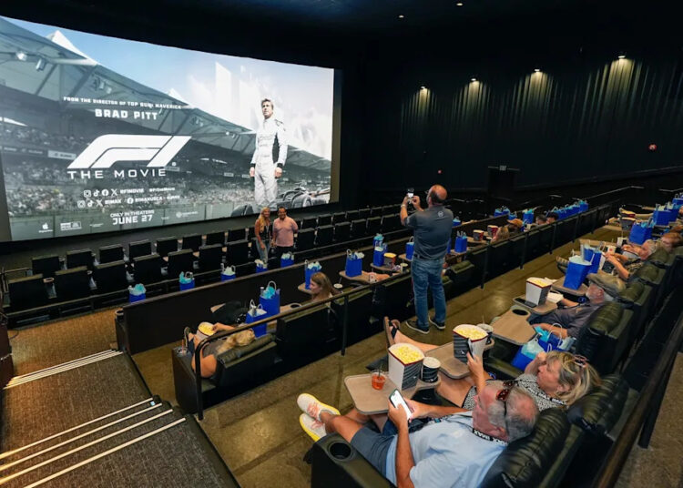 Guests prepare to watch Formula One "F1" The Movie preview screening at the CMX Daytona 12 Luxury Theatres at One Daytona, Monday, June 23, 2025.