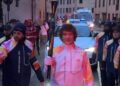 Torchbearer leading a celebration in a street during an event