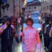 Torchbearer leading a celebration in a street during an event