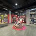 Store interior with colorful wall displays, merchandise, and mannequins dressed in casual wear.