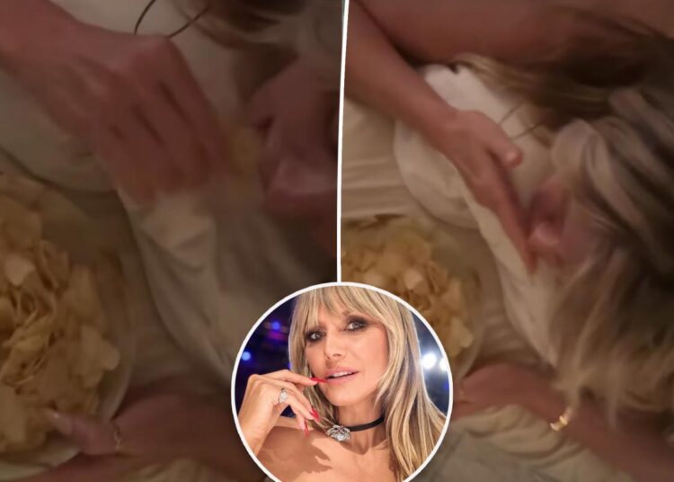 Heidi Klum gets a butt massage while eating potato chips
