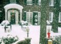 snowcovered house entrance with holiday decorations