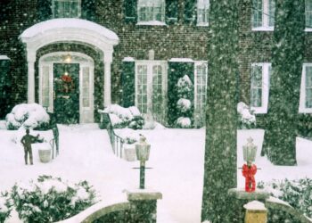 snowcovered house entrance with holiday decorations