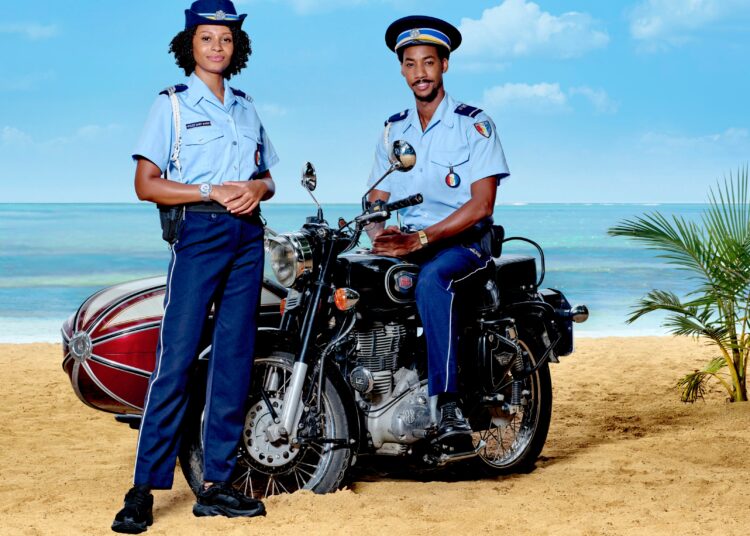 (L-R) Sergeant Mattie Fletcher (CATHERINE GARTON), Sebastian Rose (SHAQUILLE ALI-YEBUAH) in Death in Paradise season 15