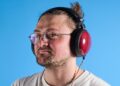 the fiio ft13 wired headphones with wood cups and copper cable photographed against a blue background