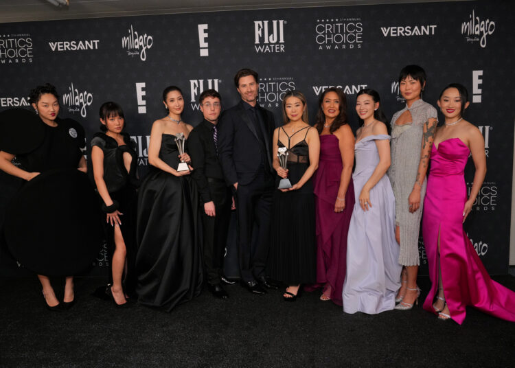 The cast and crew of Netflix's animated hit ″KPop Demon Hunters″ (2025) pose for a photo after the film received Best Animated Feature at the 31st Critics Choice Awards at The Barker Hanger in Santa Monica, California, on Jan. 4. From left is Audrey Nuna, Rei Ami, Ejae, Mark Sonnenblick, Chris Appelhans, Maggie Kang, Michelle Wong, Arden Cho, May Hong and Yoo Ji-young. [AP/YONHAP]
