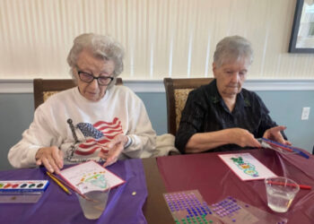 Crafting club members Margaret Kasyan and Martha Aregood work on...