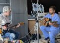 Loren Vinal plays his guitar, heart transplant recipient with AJ Rodgers, nurse