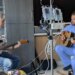 Loren Vinal plays his guitar, heart transplant recipient with AJ Rodgers, nurse