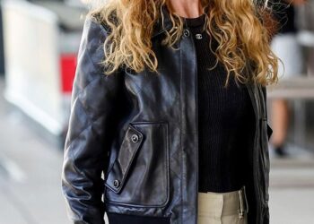 She wore a black leather jacket, cream pants, white sneakers, black sunglasses and a designer Chanel bag.