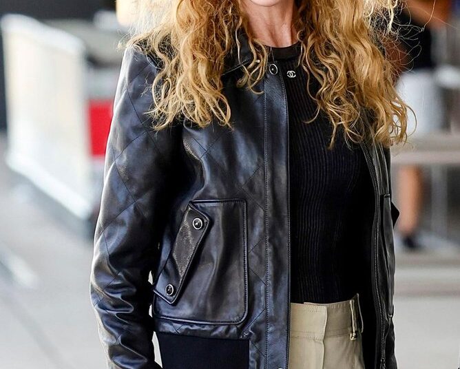 She wore a black leather jacket, cream pants, white sneakers, black sunglasses and a designer Chanel bag.