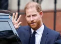 EPA Prince Harry waves as he steps from the door of a black car