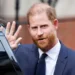 EPA Prince Harry waves as he steps from the door of a black car