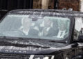 Prince Harry in a black car with two other men, leaving Clarence House.