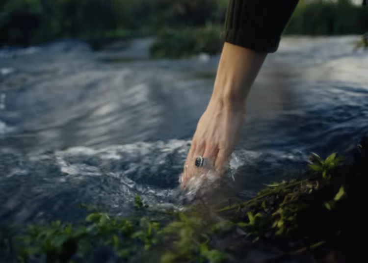 Princess Kate sticking her hand in a stream