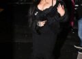 Rihanna exiting a vehicle, wearing a black outfit.