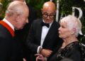 Charles speaks to Stanley Tucci and Dame Judi Dench in the Grand Reception Room after they attended the premiere on Wednesday