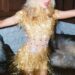 dancer in a shimmering gold outfit with fringe