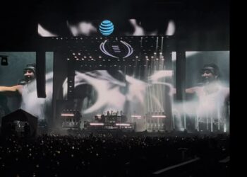 a DJ on stage at an edm concert