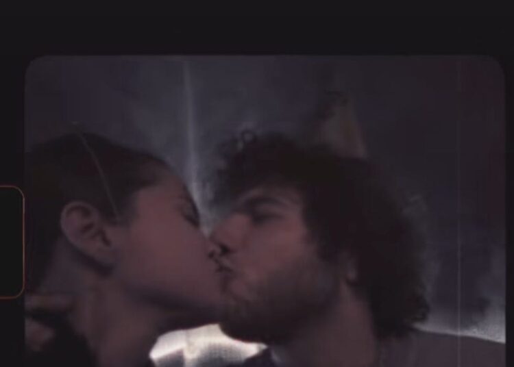 celebratory moment with two people sharing a kiss