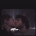 celebratory moment with two people sharing a kiss