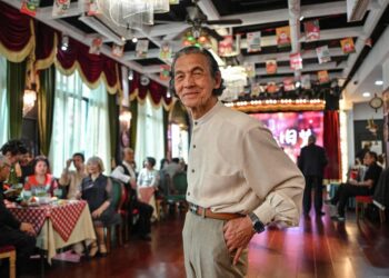 An elderly man poses for a picture at the Hai Shang Jiu Meng Dance Hall in Shanghai. For the elderly, dance halls are gyms, entertainment venues and social clubs rolled into one. Photo: AFP