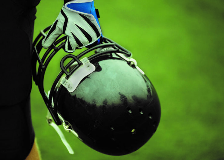 Player holding football helmet