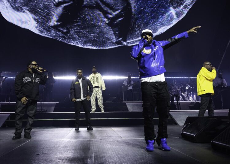 Several rappers perform live on stage.