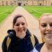 Lauren and Brianna take a smiling selfie in the middle of a university grounds.