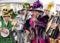 Members of various Mummers clubs’ string bands play their instruments in colorful outfits