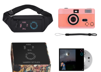 Merchandise set featuring a camera, fanny pack, and boxed album.