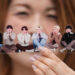 A fan poses with a group photo of BTS during a celebration marking the band's 12th debut anniversary in Goyang, Gyeonggi, on June 13, 2025. [AP/YONHAP]