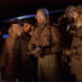 The cast of The Thing (1982) looking at a glowing light
