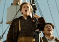 Jack and Fabrizio standing at the front of the Titanic in Titanic (1997)