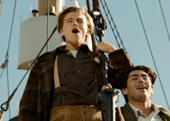 Jack and Fabrizio standing at the front of the Titanic in Titanic (1997)
