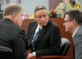 Nathan Chasing Horse, center, confers with attorneys as he appears in court for his trial on charges of sexually abusing Indigenous women and girls Tuesday, Jan. 20, 2026, in Las Vegas. (AP Photo/John Locher)