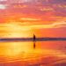 A man walks on the beach at sunset in Uvita.
