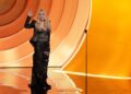 A smiling Cher laughs at her Grammys flubs in a good-natured, chaotic appearance