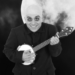 A black and white photo of the lovable Uncle Fester playing a banjo against the backdrop of a full moon. (Courtesy photo)
