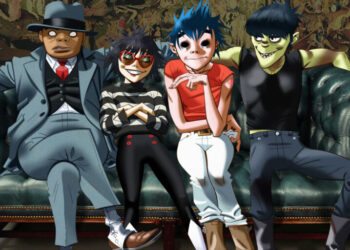 Gorillaz band members sitting on a couch for their press photo