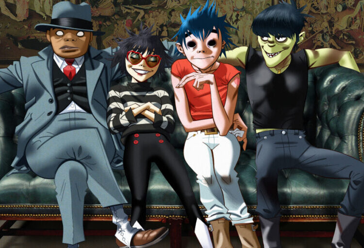Gorillaz band members sitting on a couch for their press photo